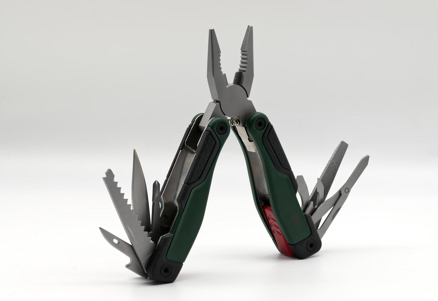 Multi tool with multiple functions and pliers isolated on white. photo
