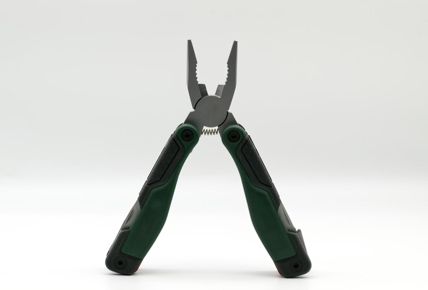 Multi tool with multiple functions and pliers on white background. photo