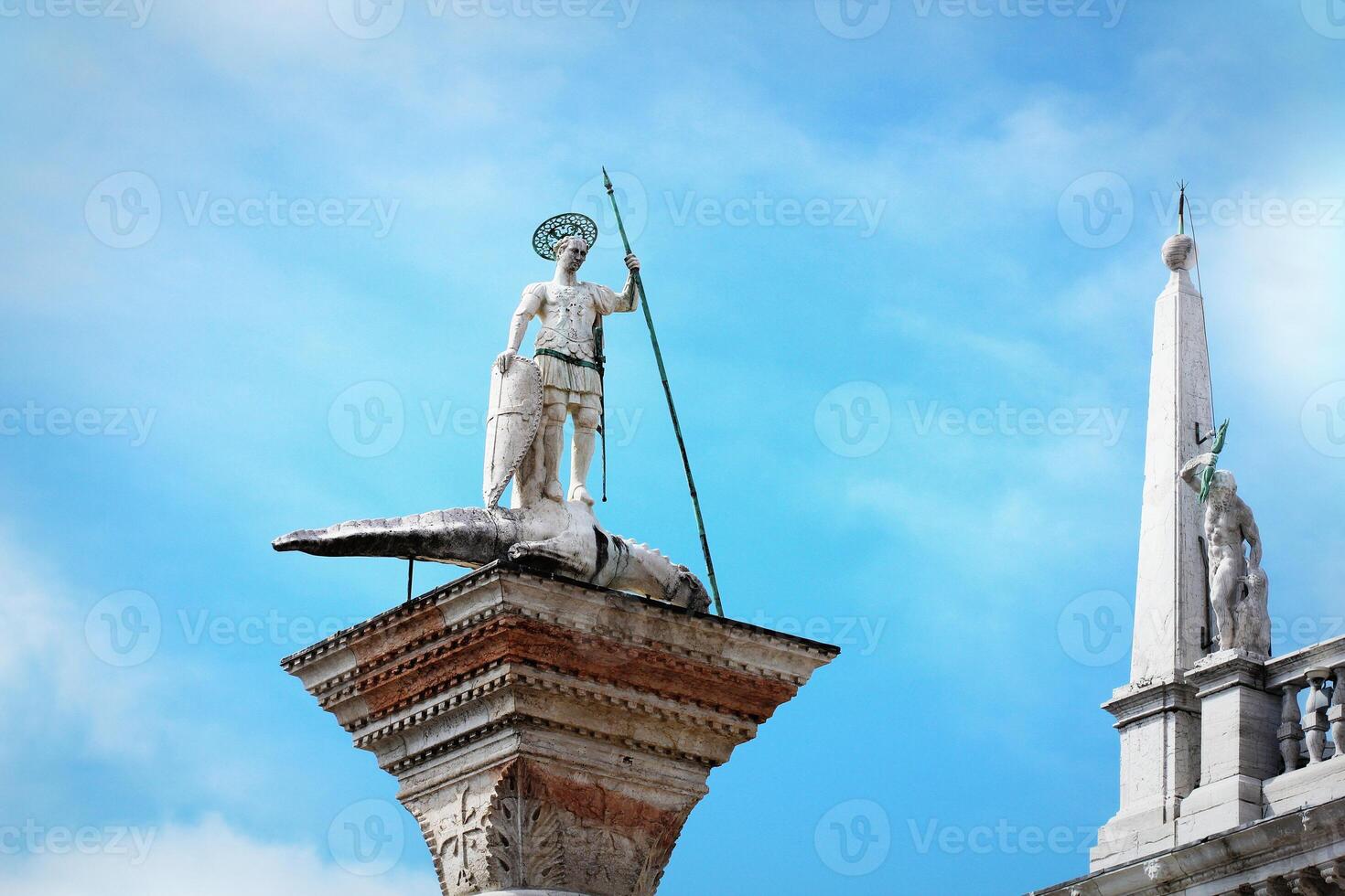 Saint Theodor statue on a column on the Piazza San Marco of Venice in Italy - Colonne di San Teodoro photo