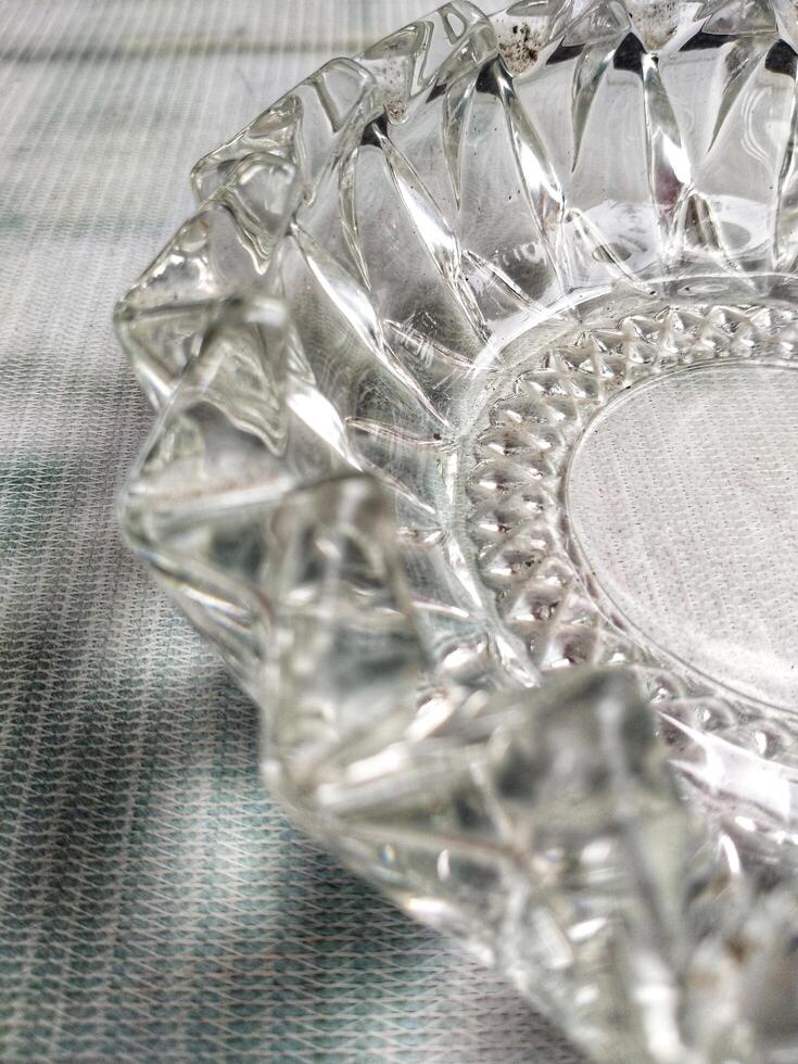 A glass ashtray on a table photo