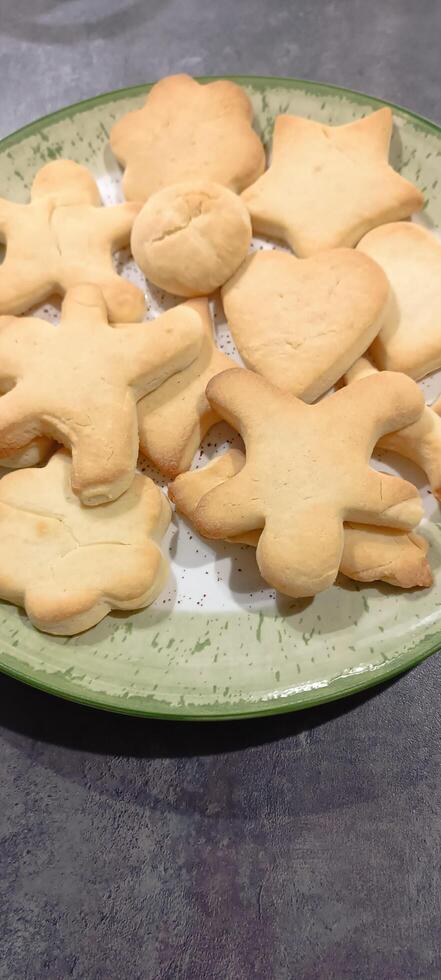 figured homemade cookies of different shapes on a flat plate. Mobile photo.. photo