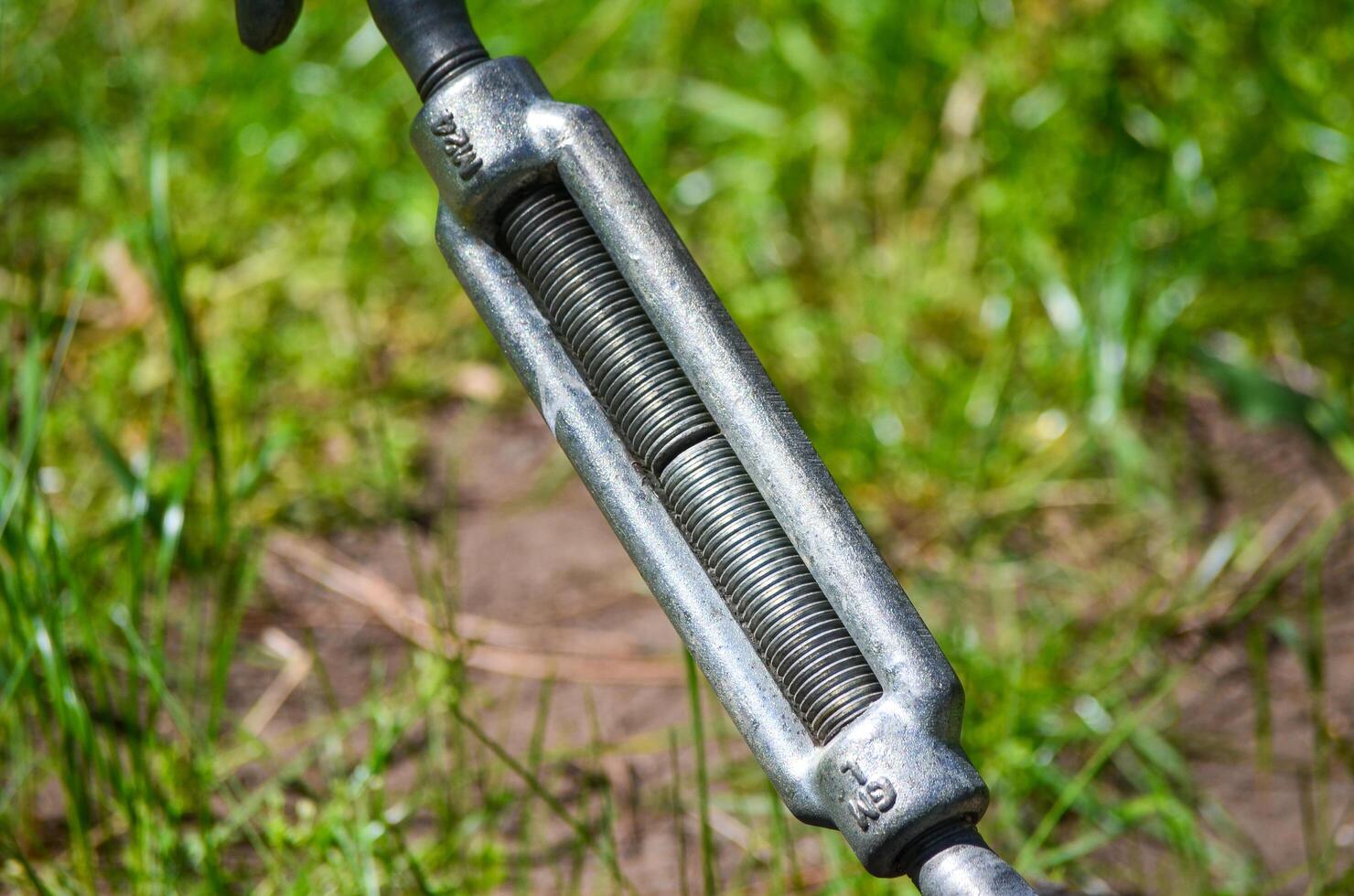 A metal object with a springy metal piece attached to it photo
