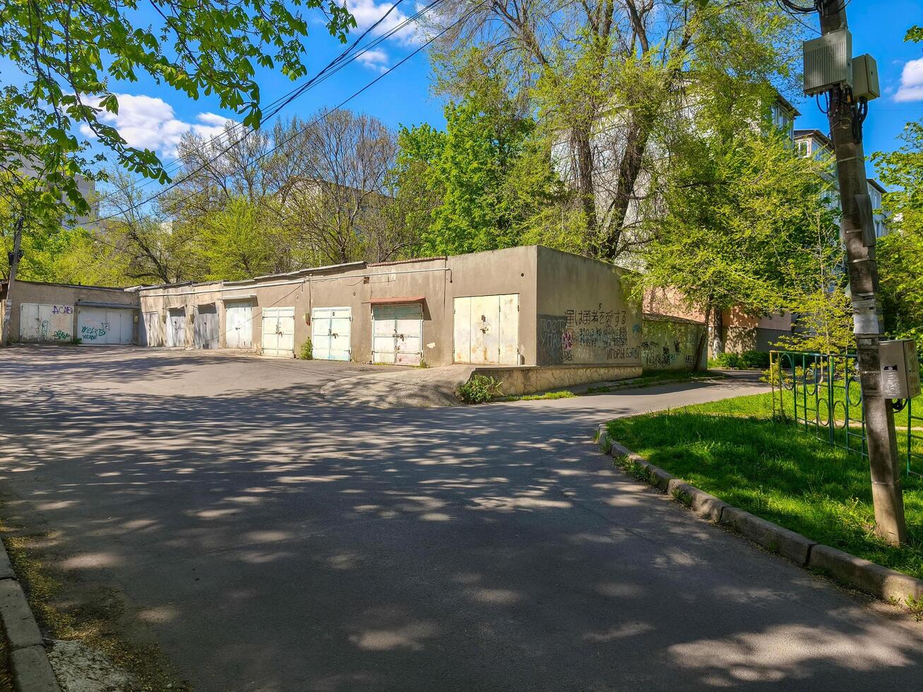 A deserted street with a building in the background. The building has a lot of graffiti on it photo
