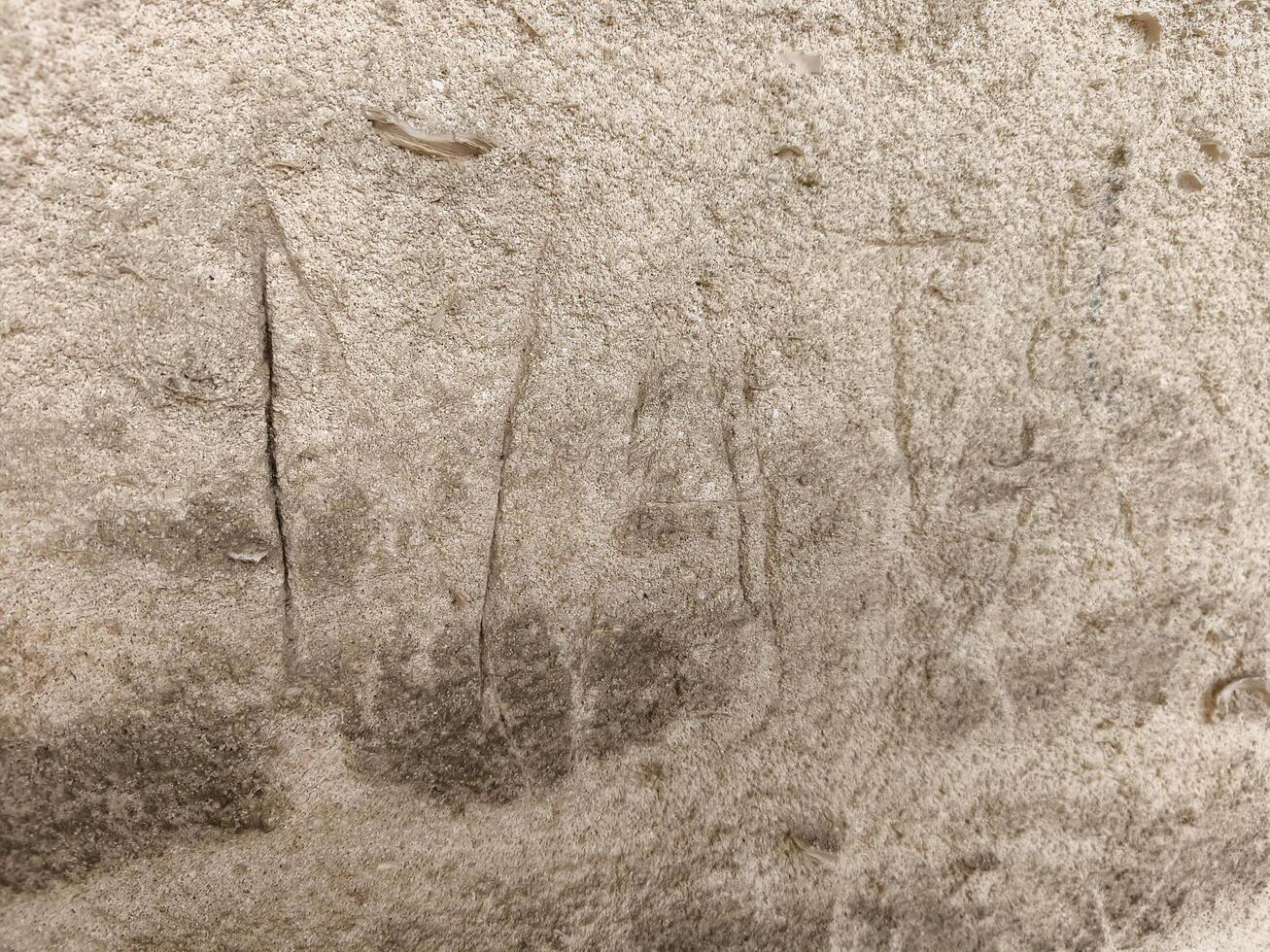 A wall with a lot of scratches and marks on it. The wall is made of concrete and has a rough texture photo