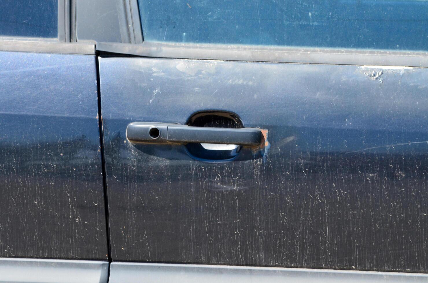 The car door is open and the handle is missing photo