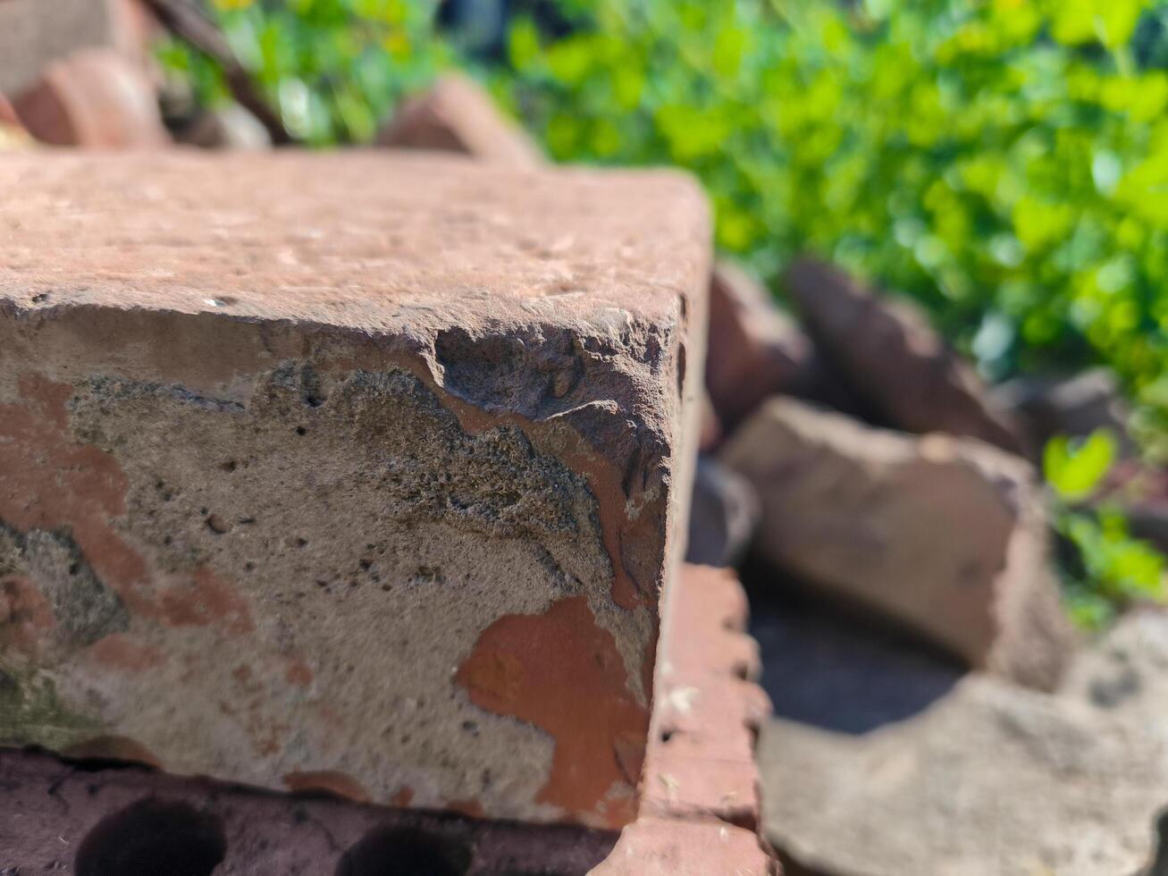 A brick wall with a crack in it. The crack is visible on the side of the brick photo