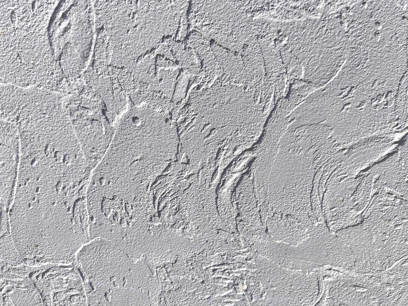 A wall with a textured surface. The texture is rough and uneven, giving the wall a rugged appearance photo