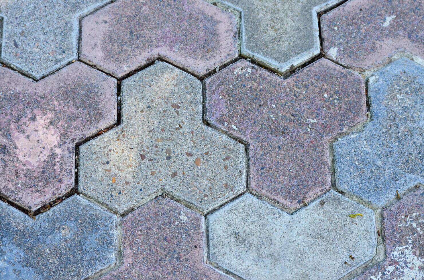 A mosaic tile pattern with a blue and pink tile. The tiles are arranged in a way that creates a sense of depth and texture photo