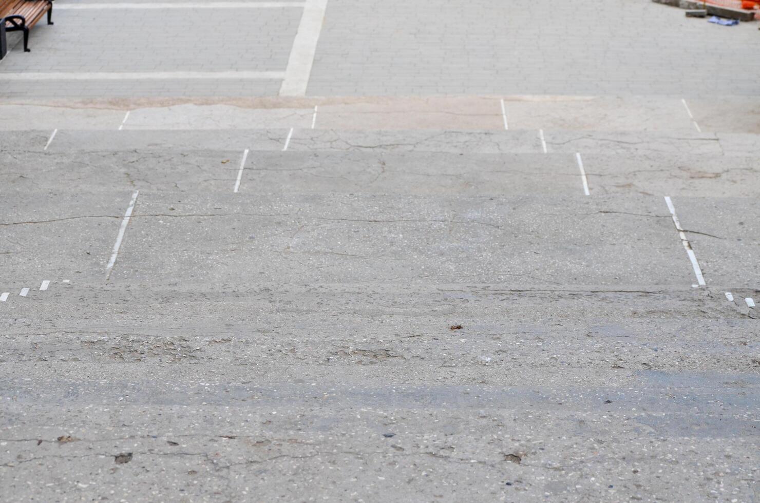 A grey concrete sidewalk with a white line painted down the middle. The sidewalk is empty and has no people or objects on itv photo