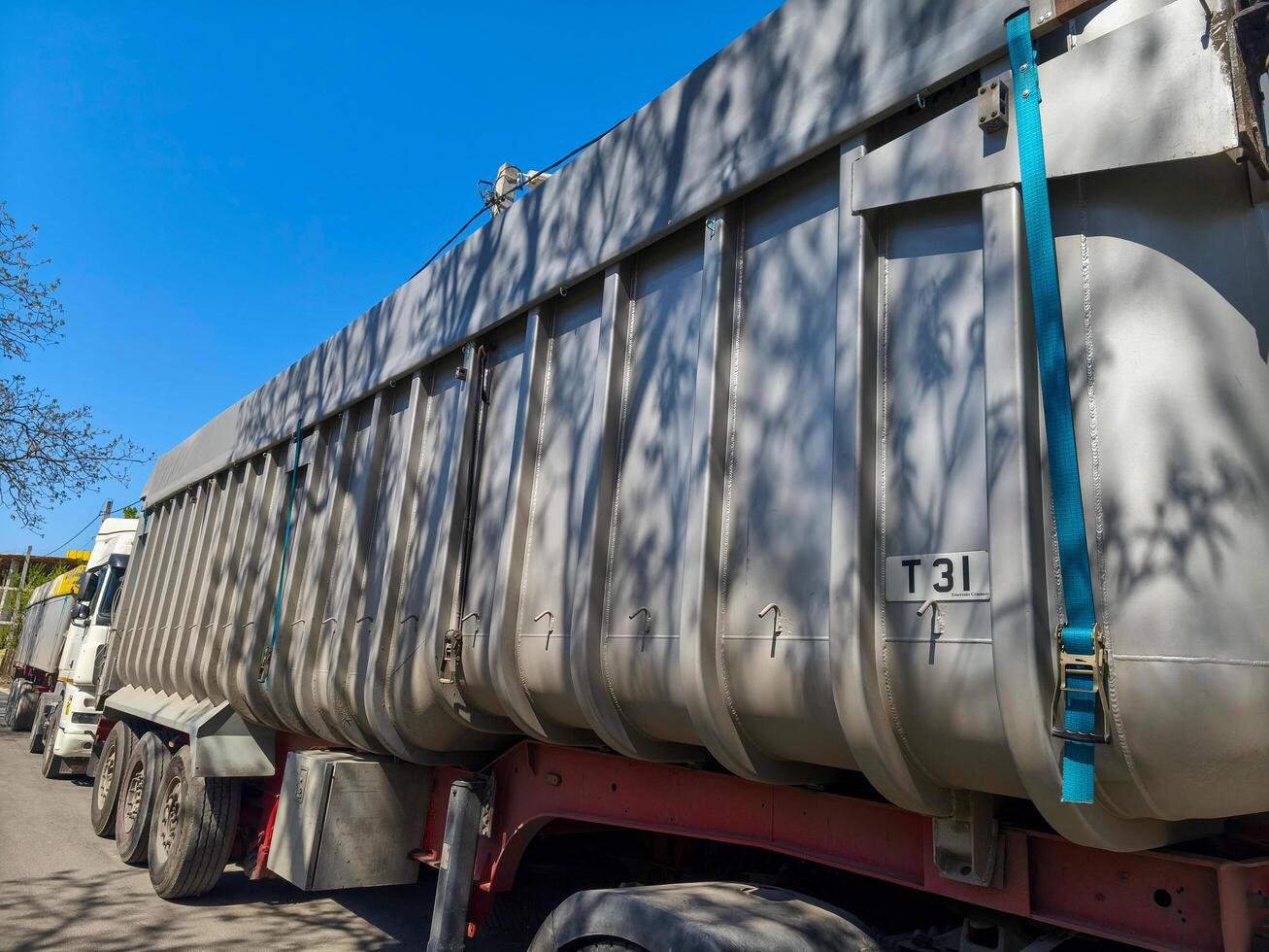 A large truck with the number T3131 on the side. The truck is parked in a lot photo