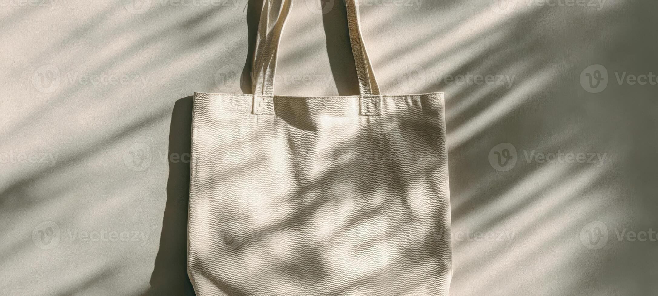 The stylish beige tote bag with soft shadows on a neutral background. photo