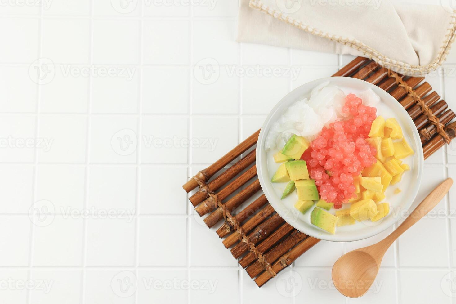 Top View Es Campur or Es Oyen is Mix Fruit with Shaved Ice Served on a Bowl photo