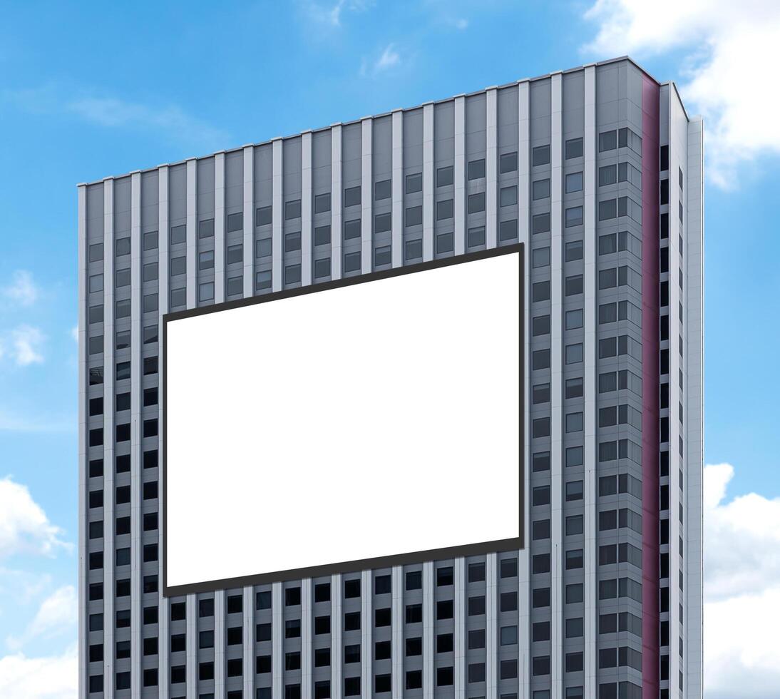 Mockup white horizontal large LED display billboard on tower building with blue sky background .clipping path for mockup photo