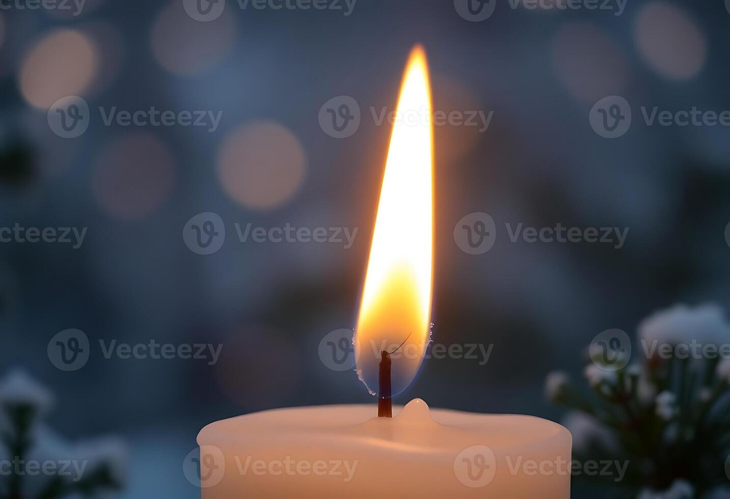 A candle is lit in the snow photo