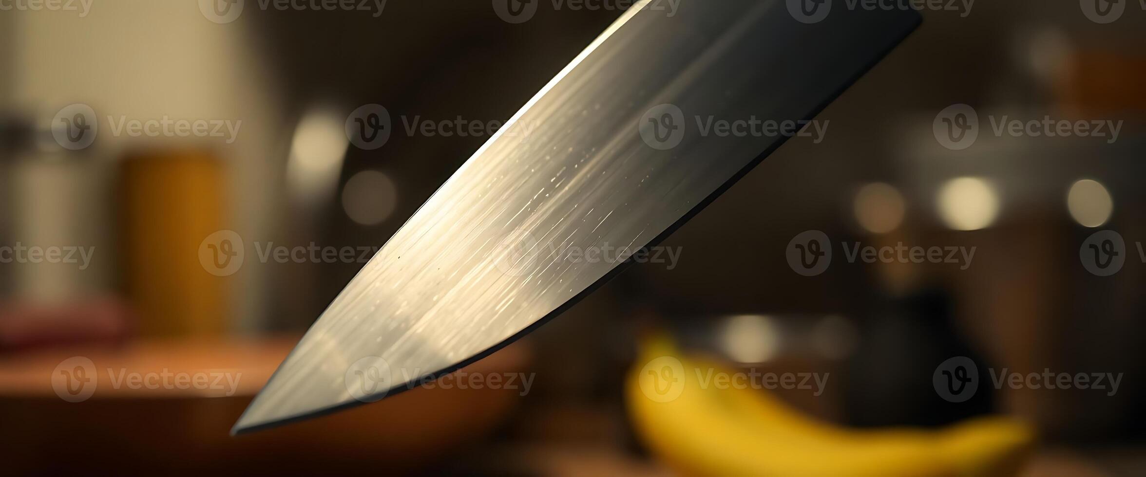 close up of a knife with a banana in the background photo