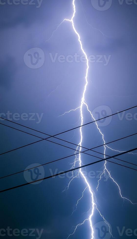 Lightning strikes over power lines in the sky photo