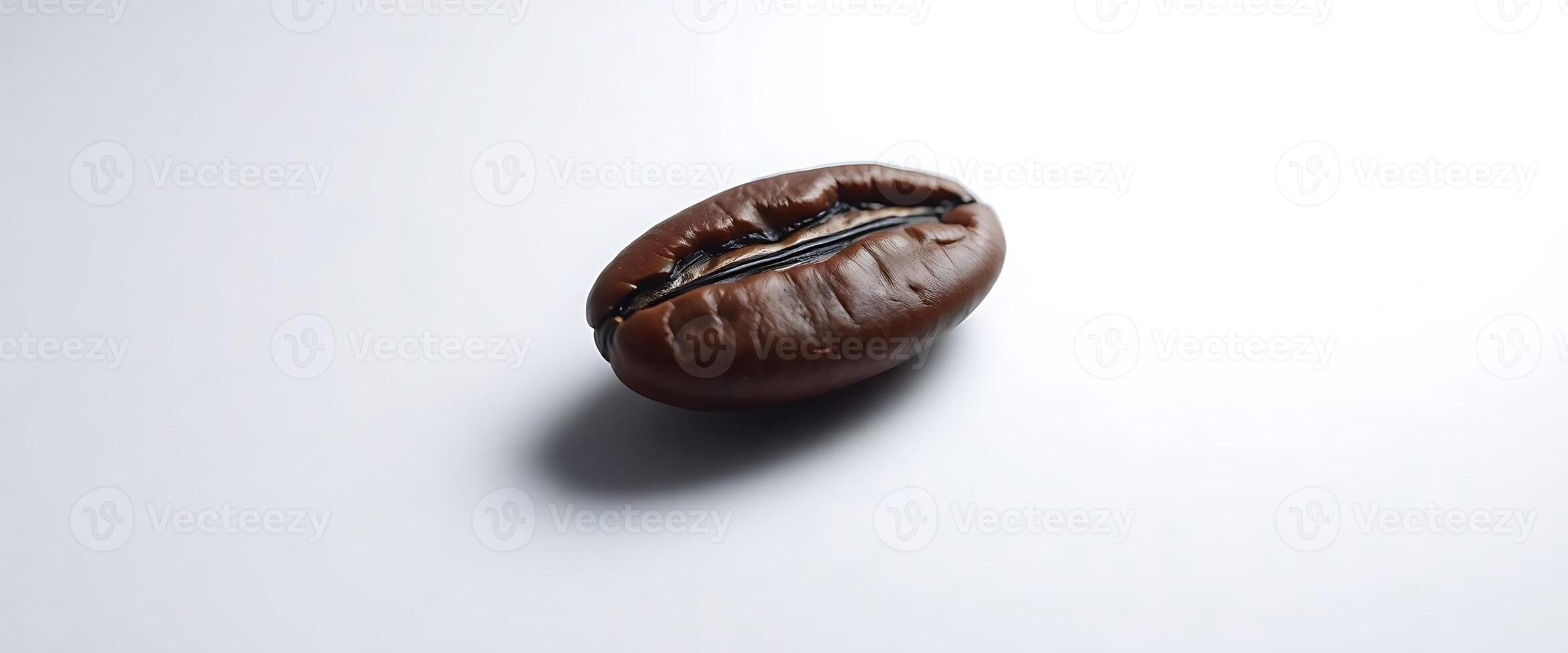 A chocolate bean on a white surface photo