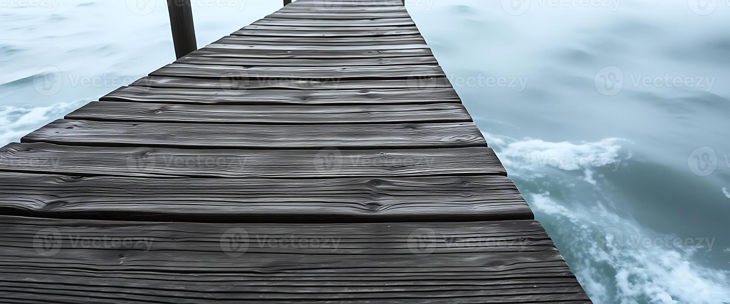 wooden dock extending into the water photo