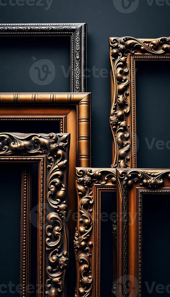 set of four ornate gold frames against a black wall photo