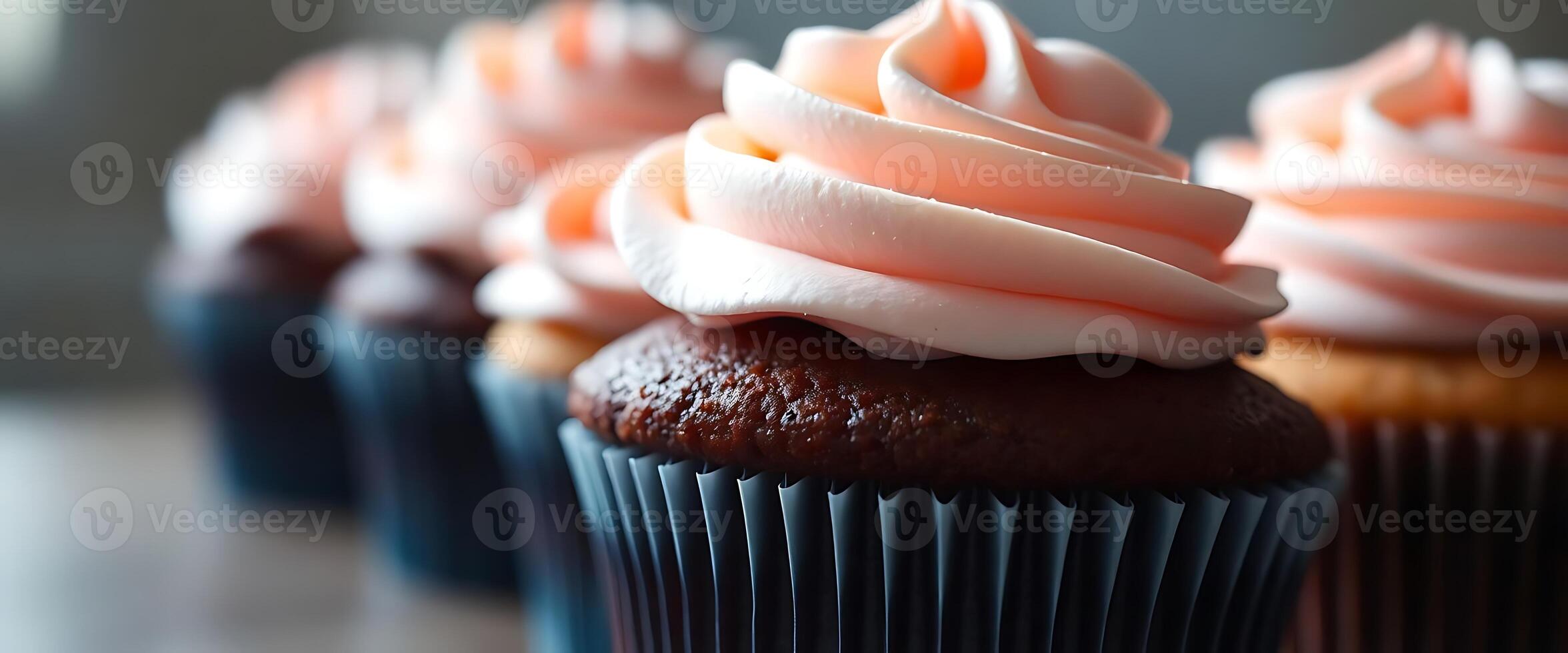row of cupcakes with frosting on top photo