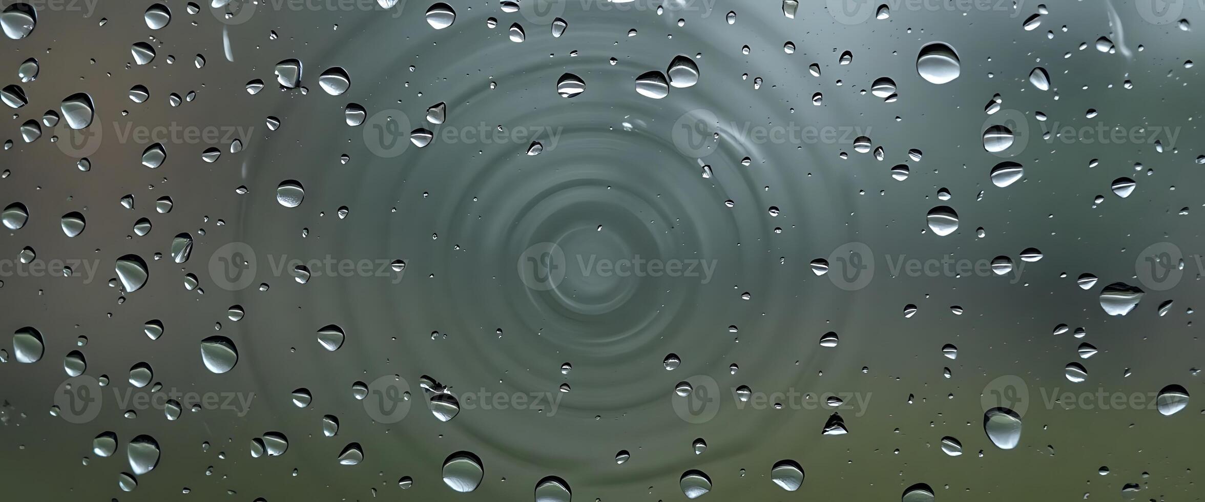 rain drops on a window with a green background photo