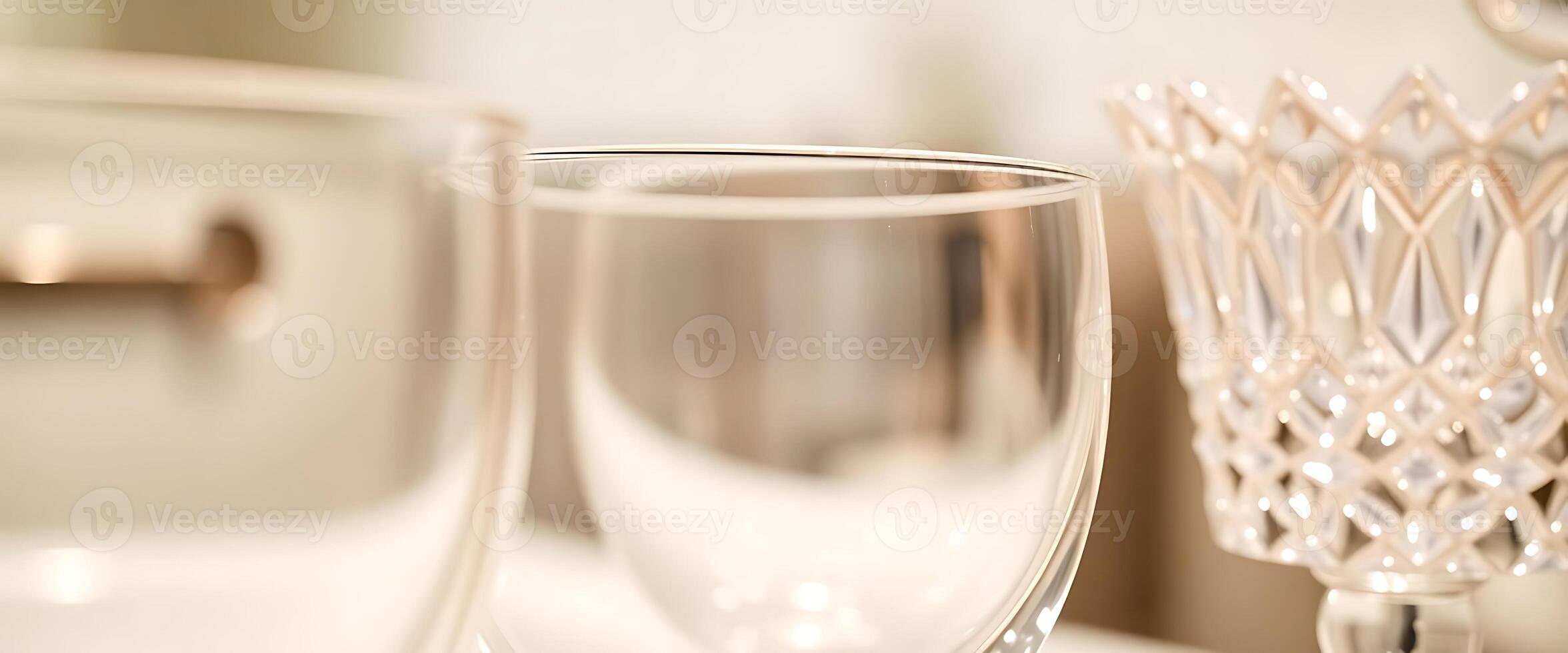 Two glasses sit on a counter next to a mirror photo