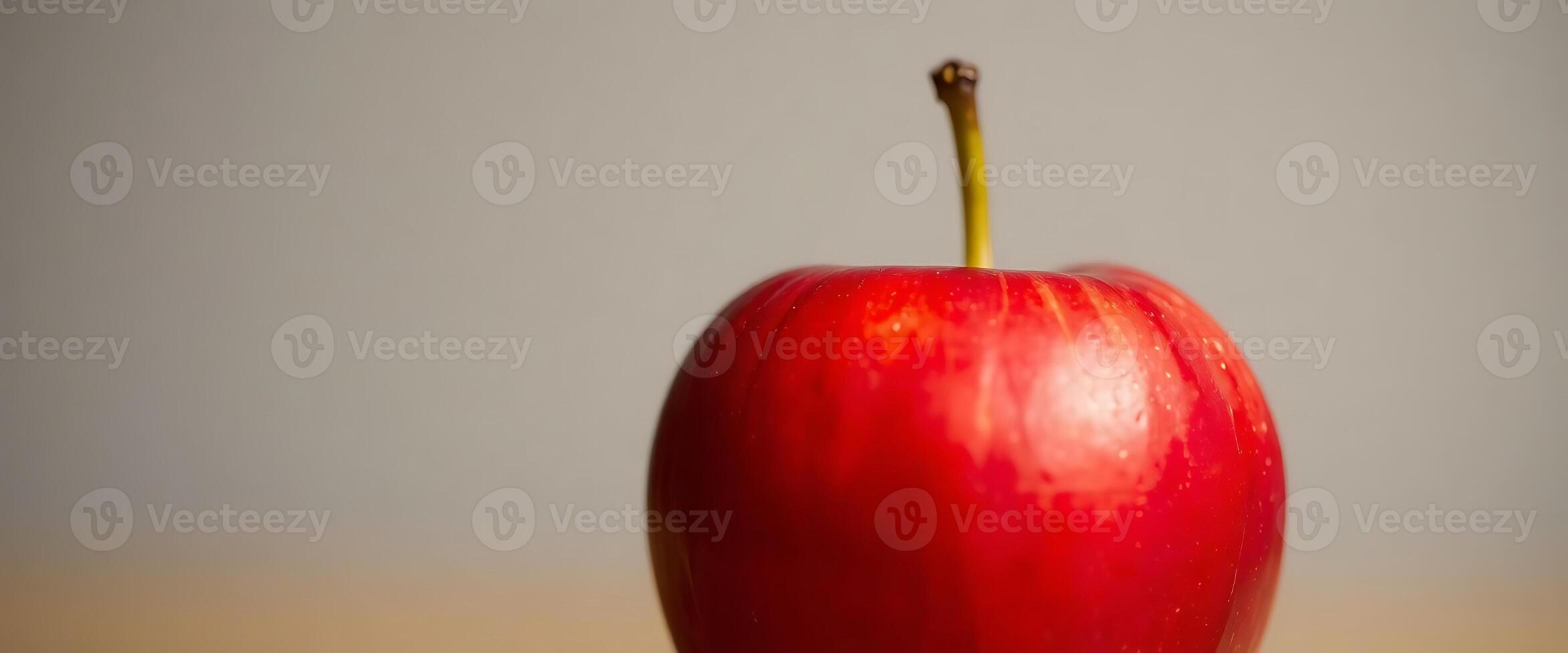 red apple sitting on top of a wooden table photo