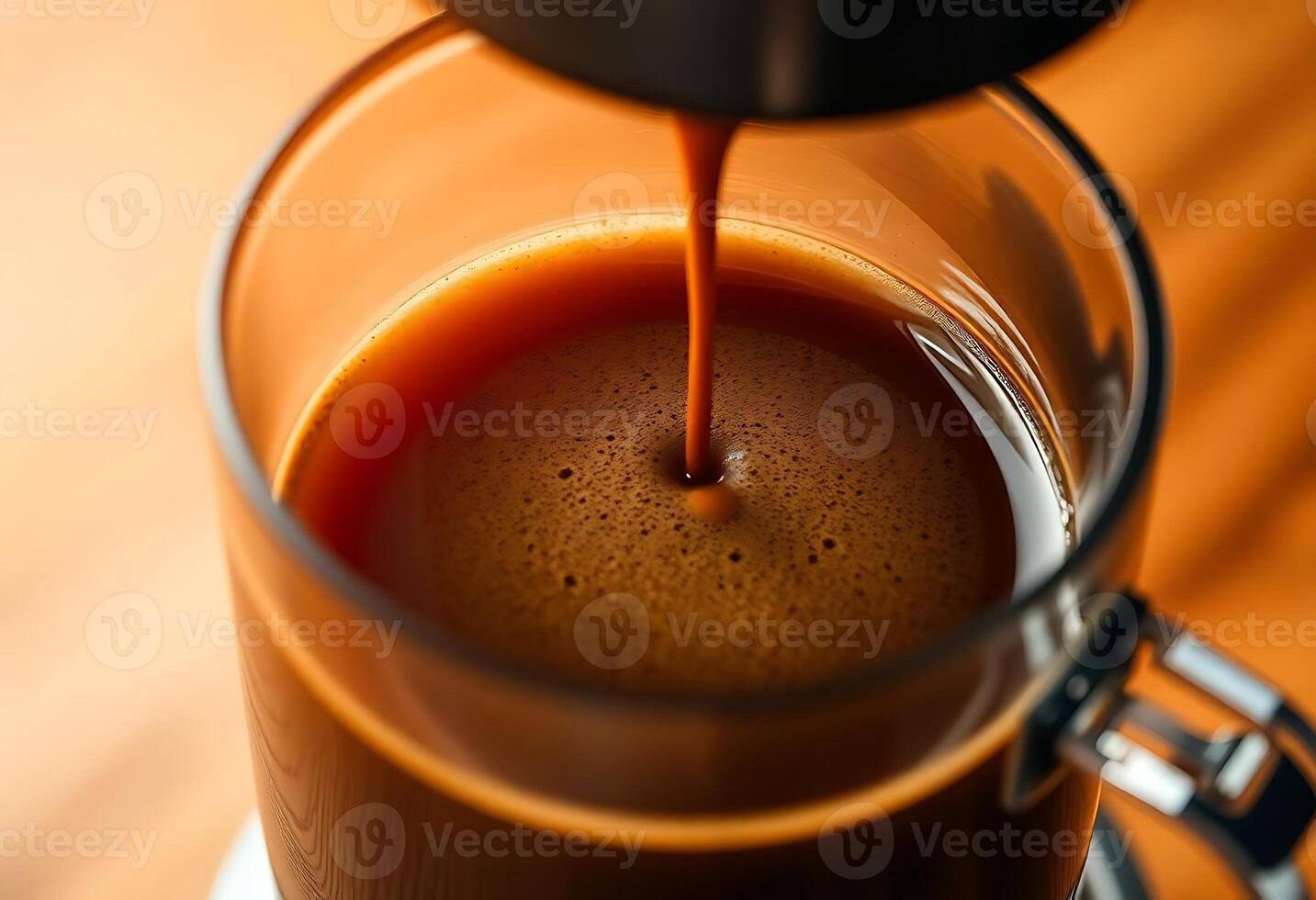 A close up of a cup of coffee being poured photo