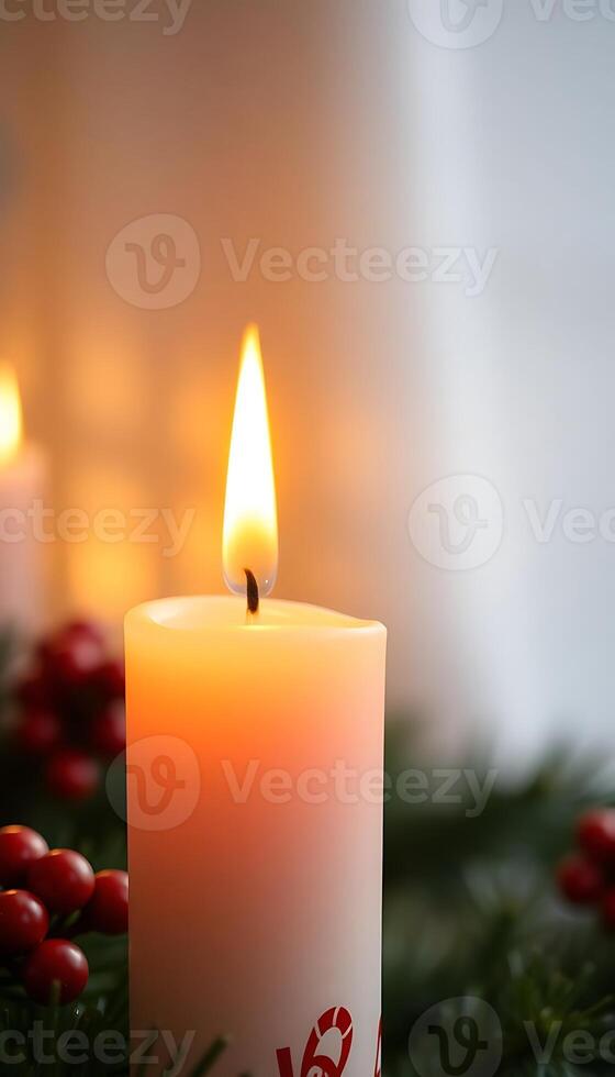 lit candle sitting on top of a christmas wreath photo