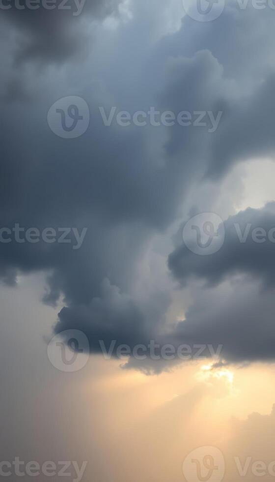 A dark cloud is seen in the sky with the sun shining through photo