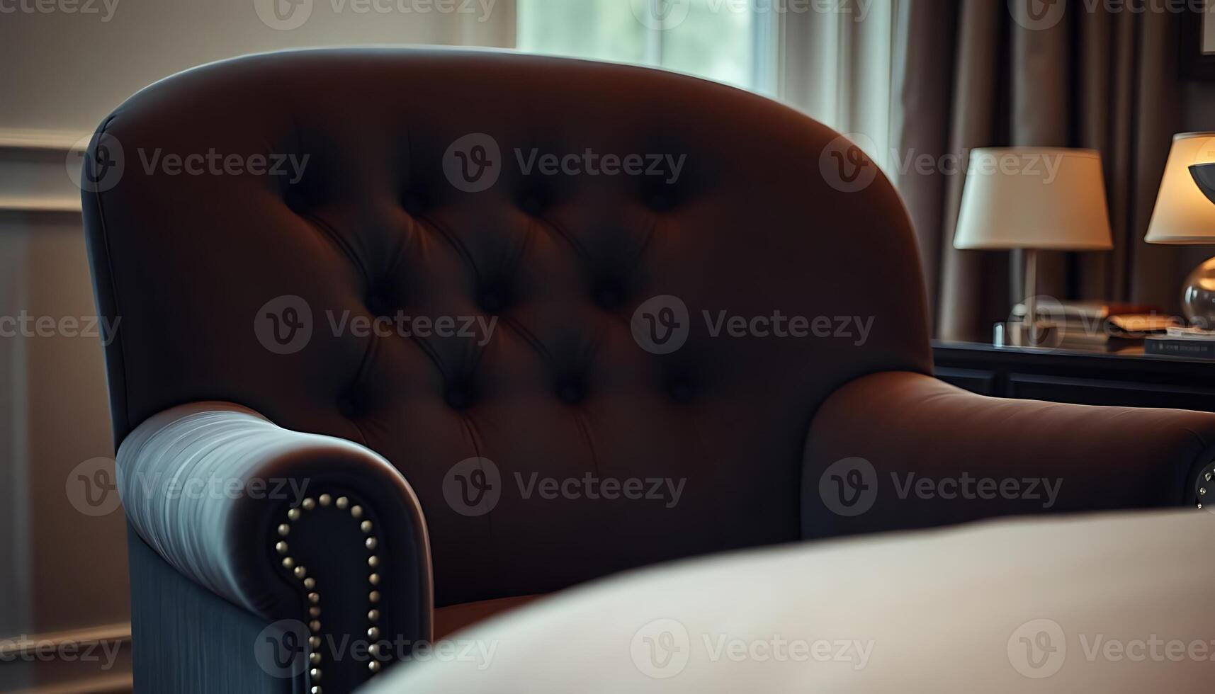brown chair sitting in a bedroom next to a lamp photo