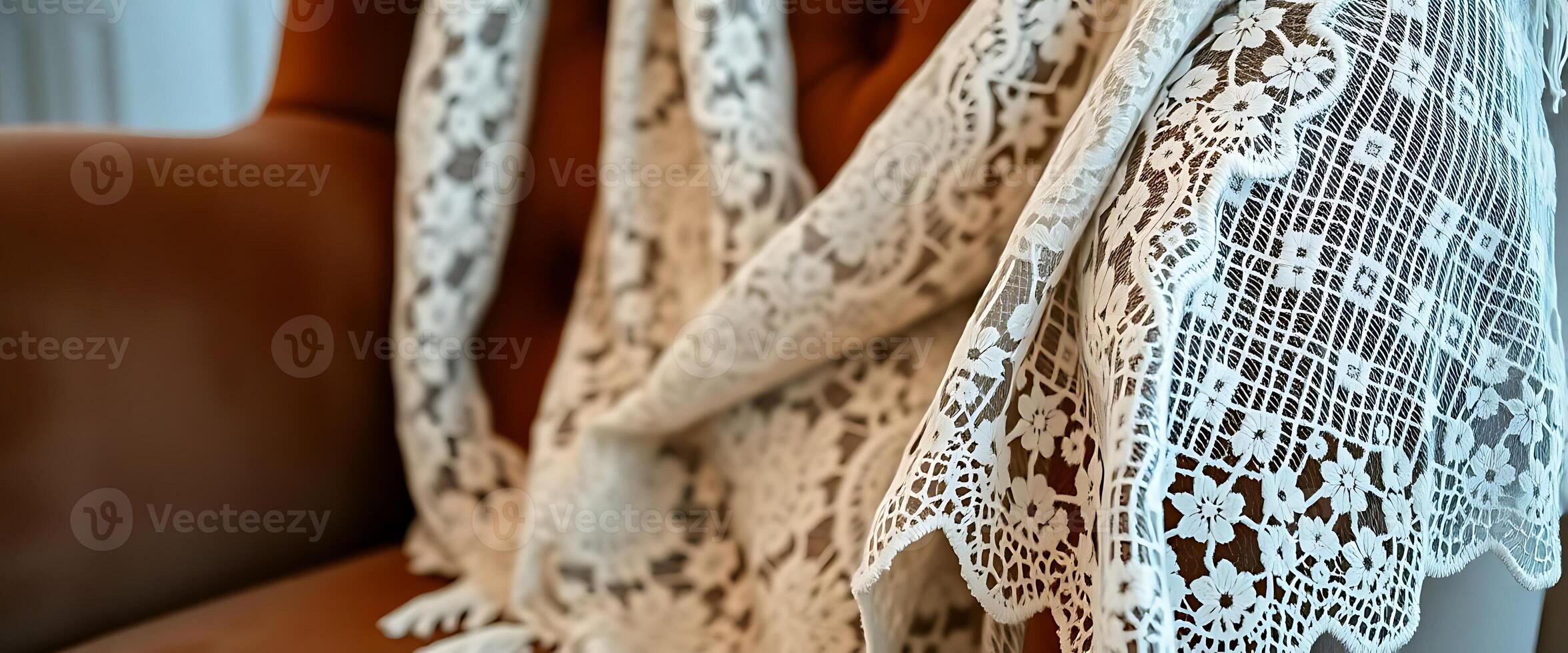 white lace curtain hanging on a brown leather chair photo