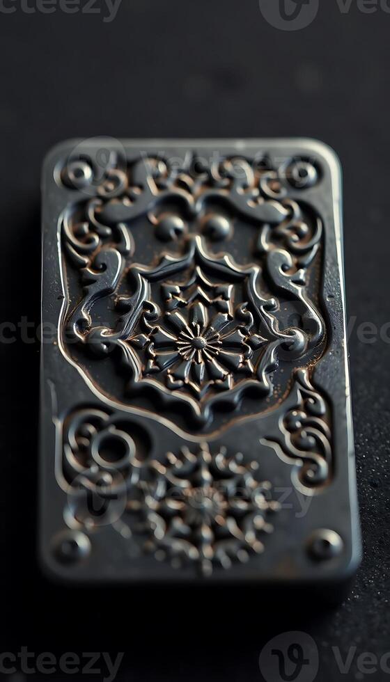 decorative metal object on a black surface photo