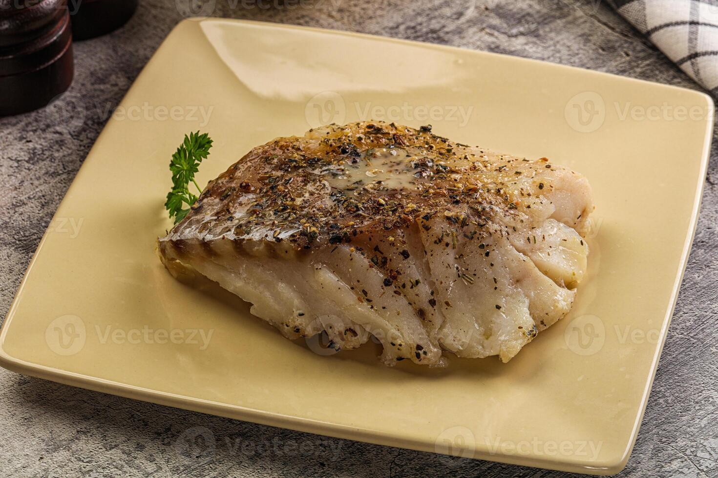 A piece of fish on a yellow plate photo