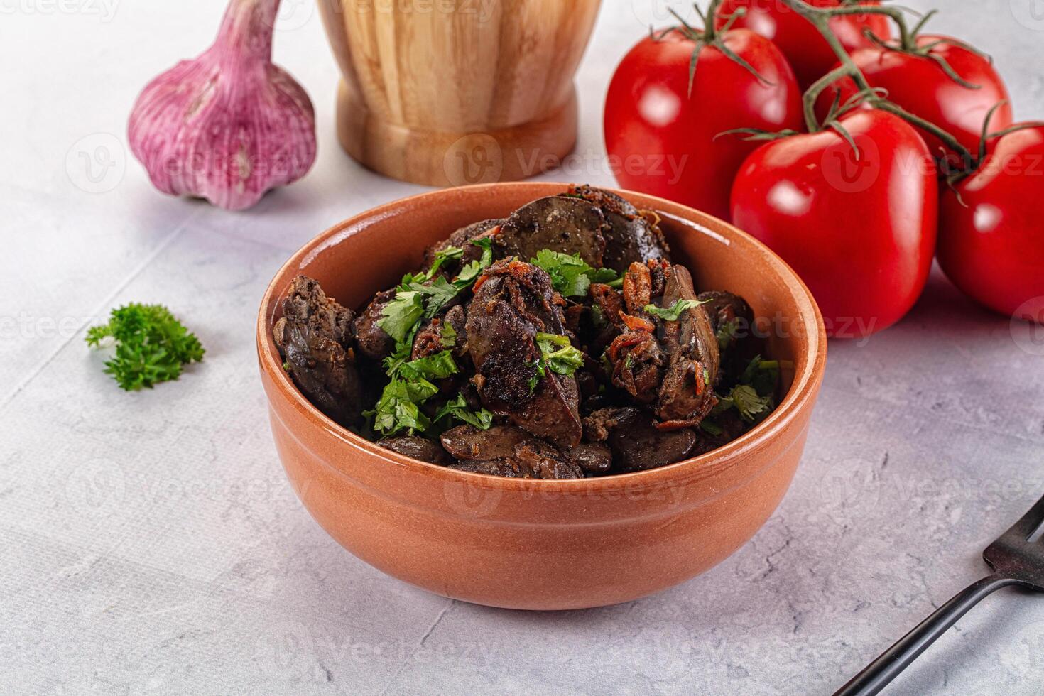 A bowl of mushrooms with herbs and tomatoes photo