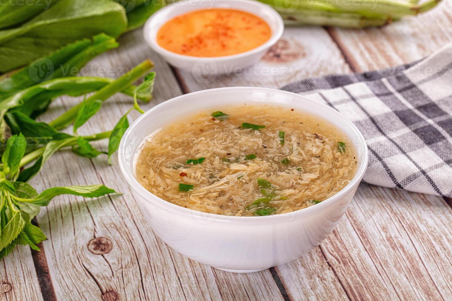A bowl of soup with herbs and vegetables photo