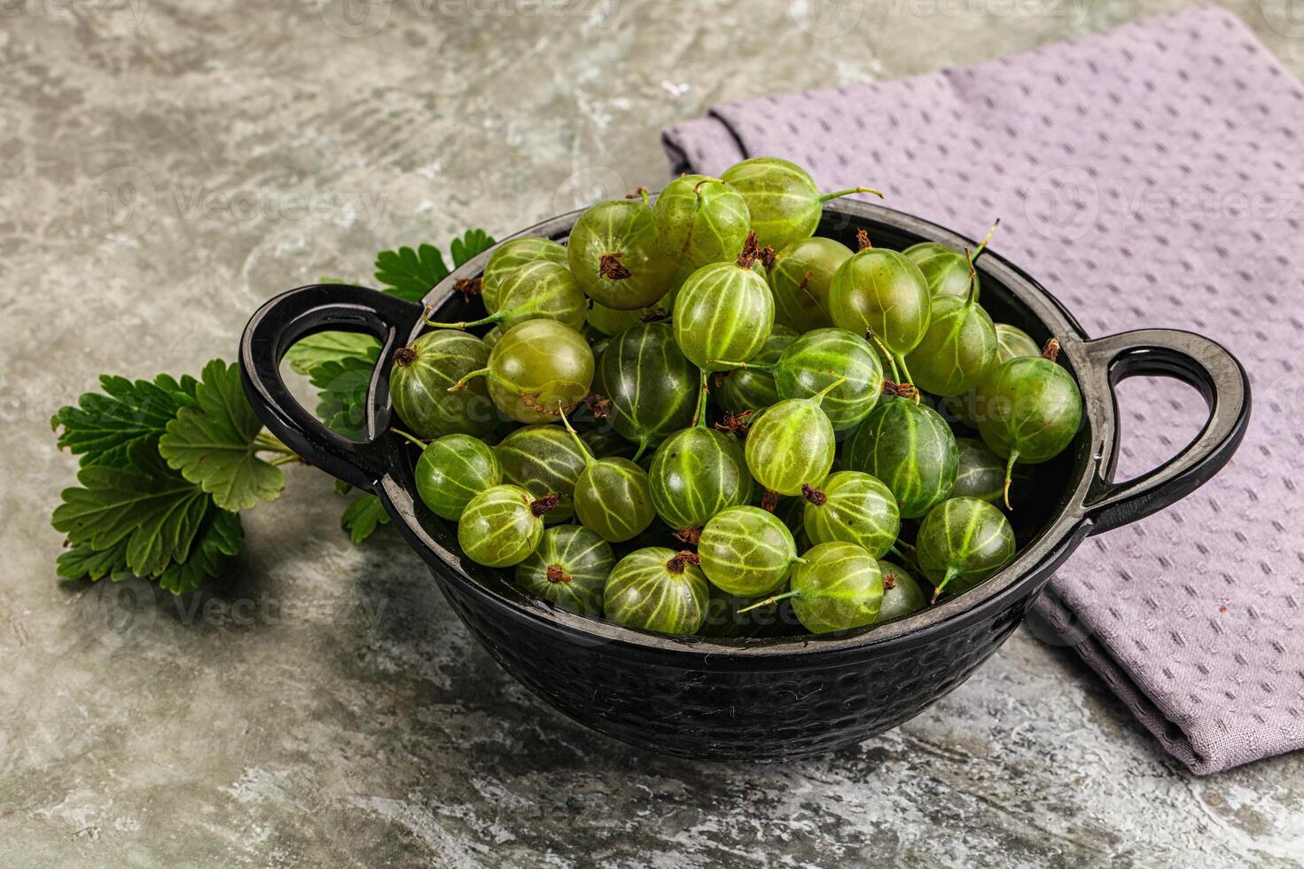 A bowl filled with green grapes on a table photo