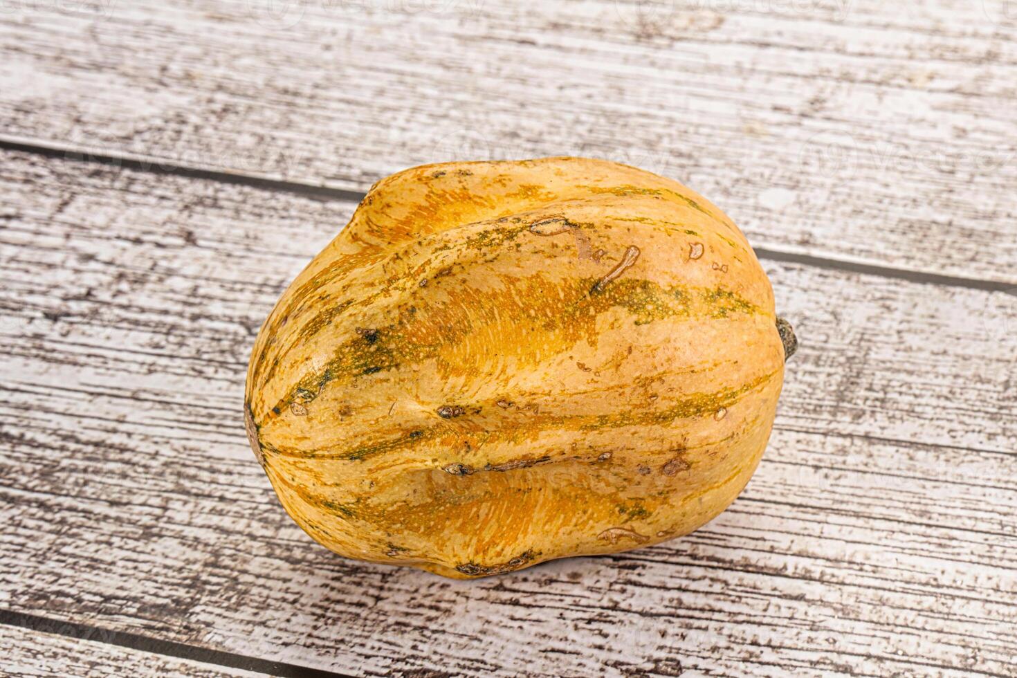 A squash on a wooden table photo