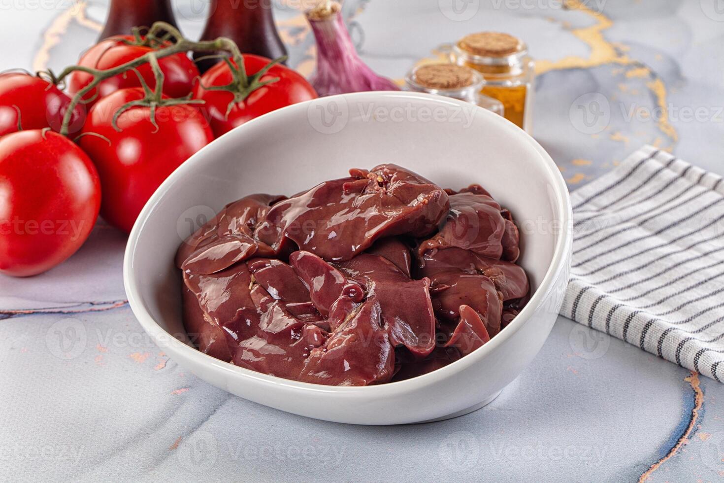 A bowl of meat and tomatoes on a counter photo