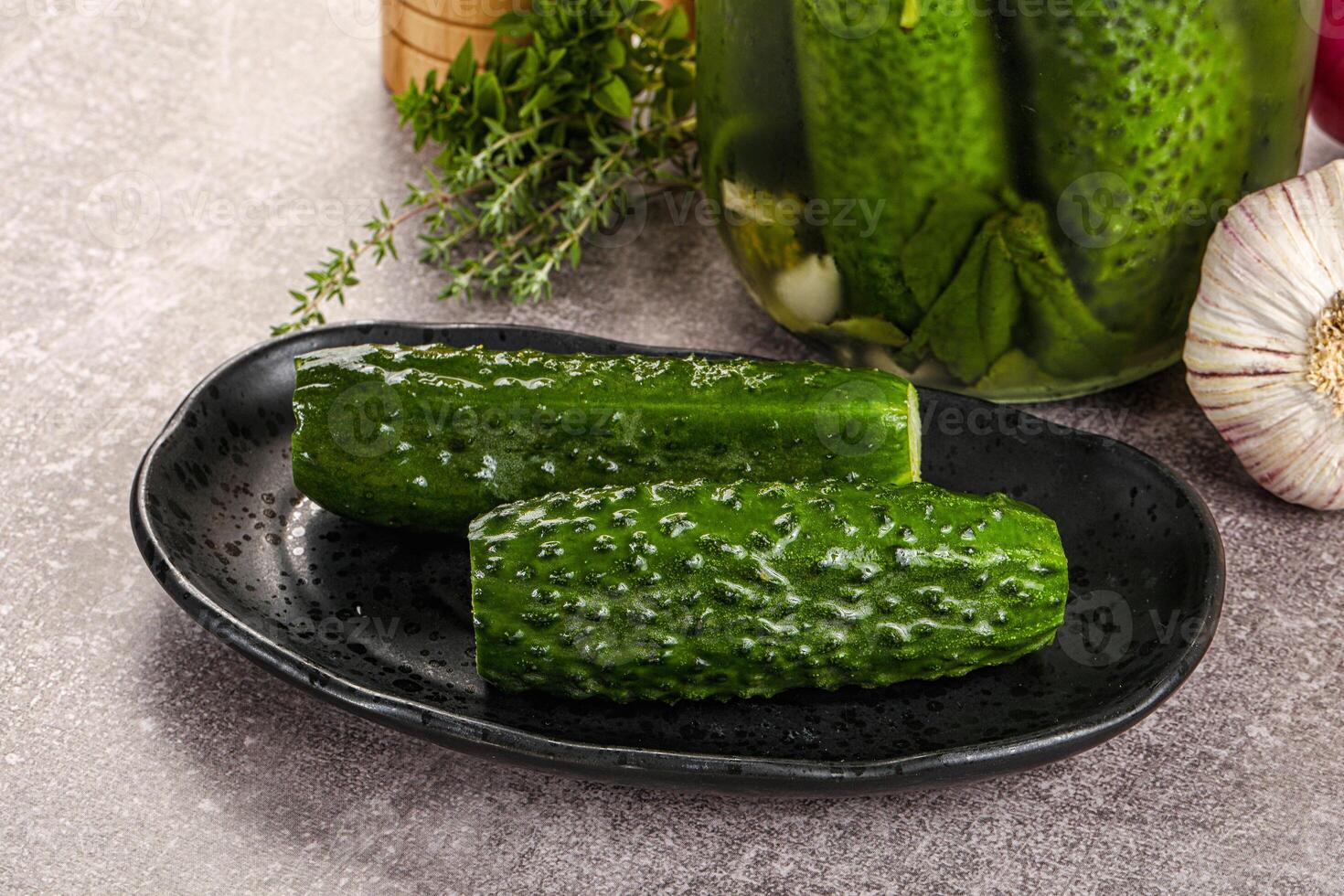 A jar of pickles and a bowl of vegetables photo