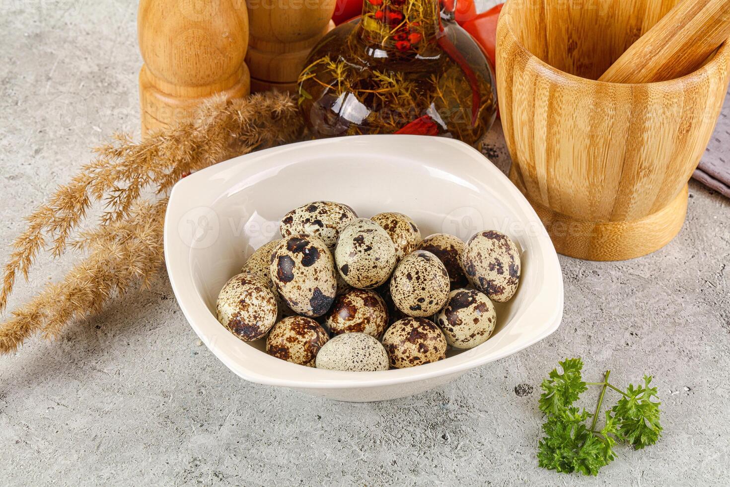 A bowl filled with quail eggs on a table photo