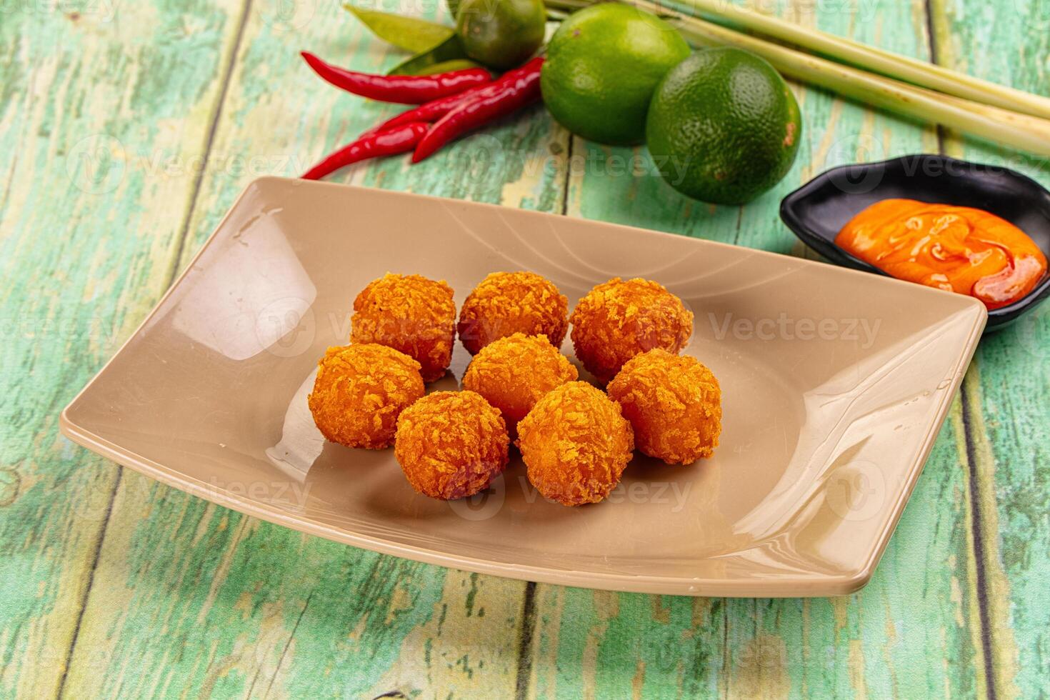 A plate of fried balls of meat on a table photo