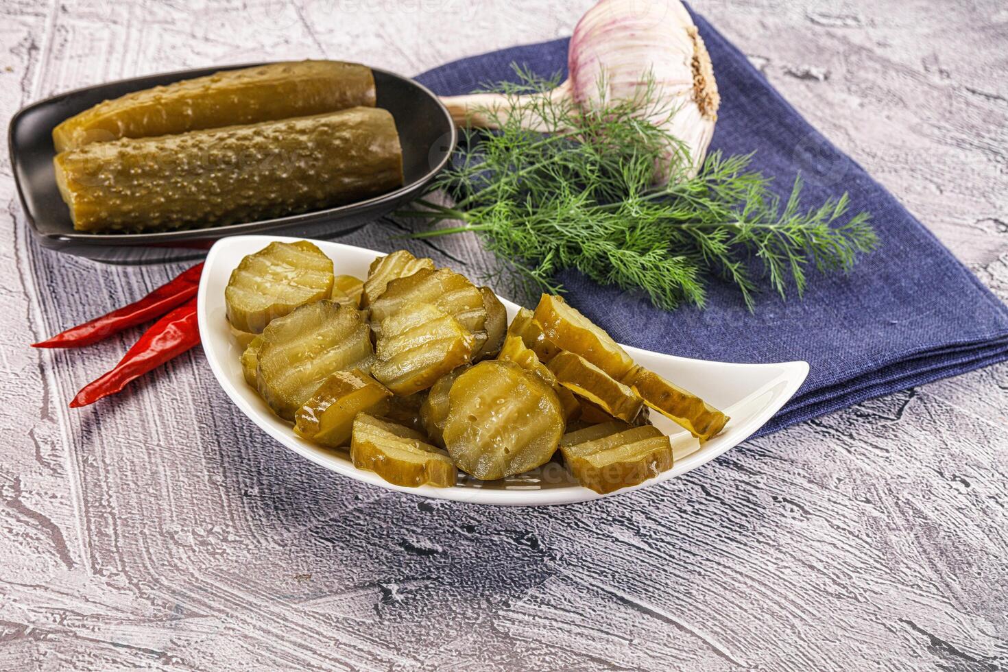 Pickles and garlic on a plate photo