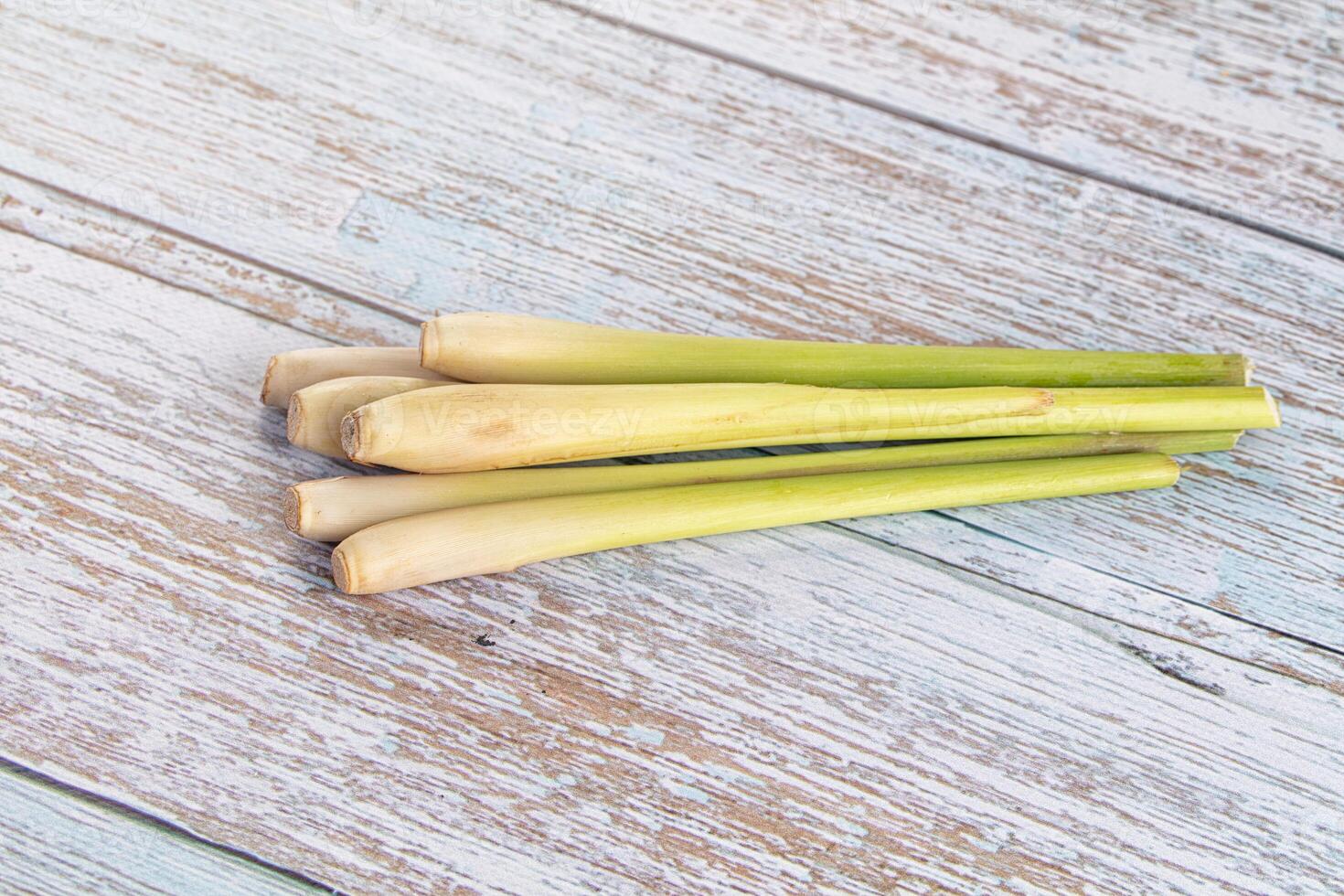 A pile of fresh green limes on a wooden table photo