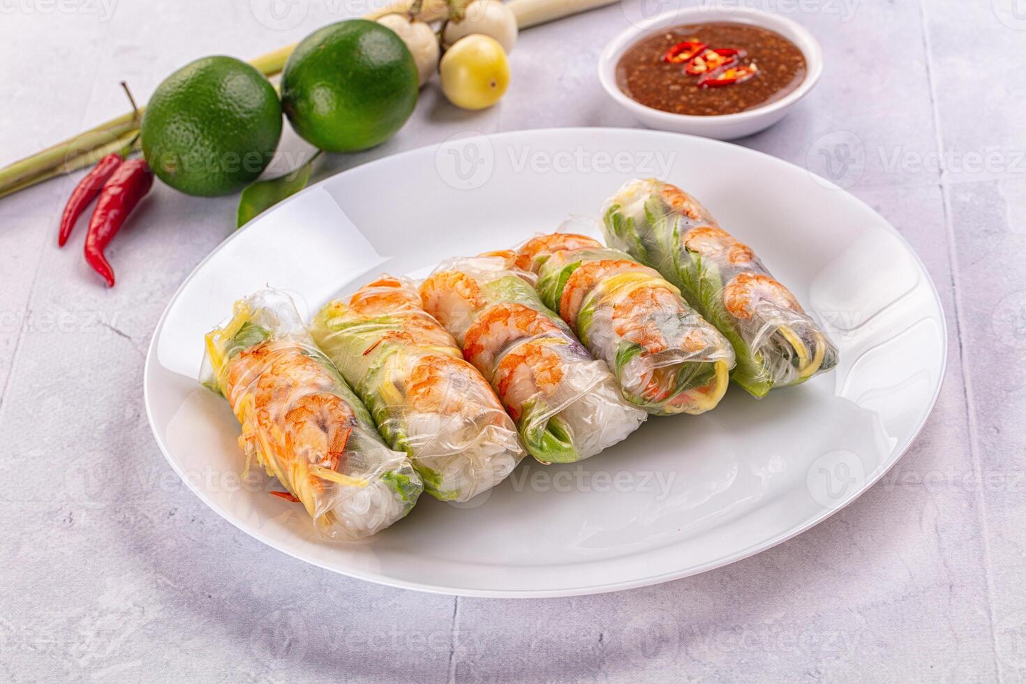 A plate with several spring rolls on it photo