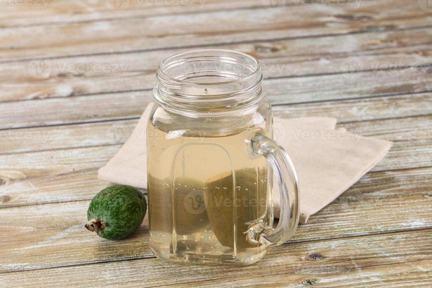 A glass jar with a glass mason jar filled with water and a lime photo