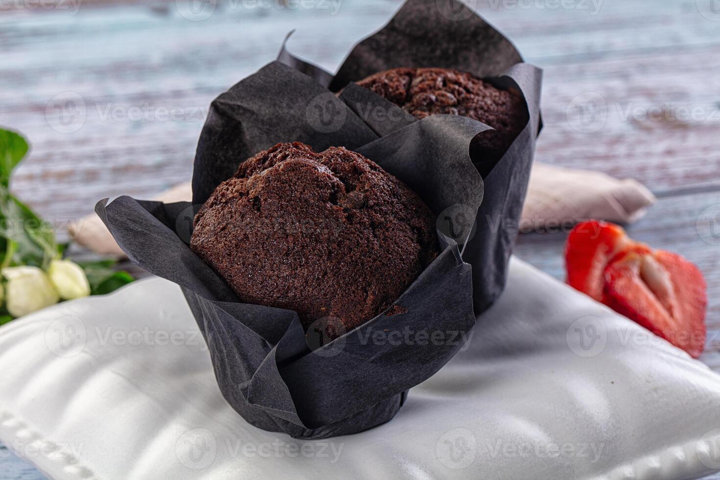 A chocolate muffin on a white plate photo