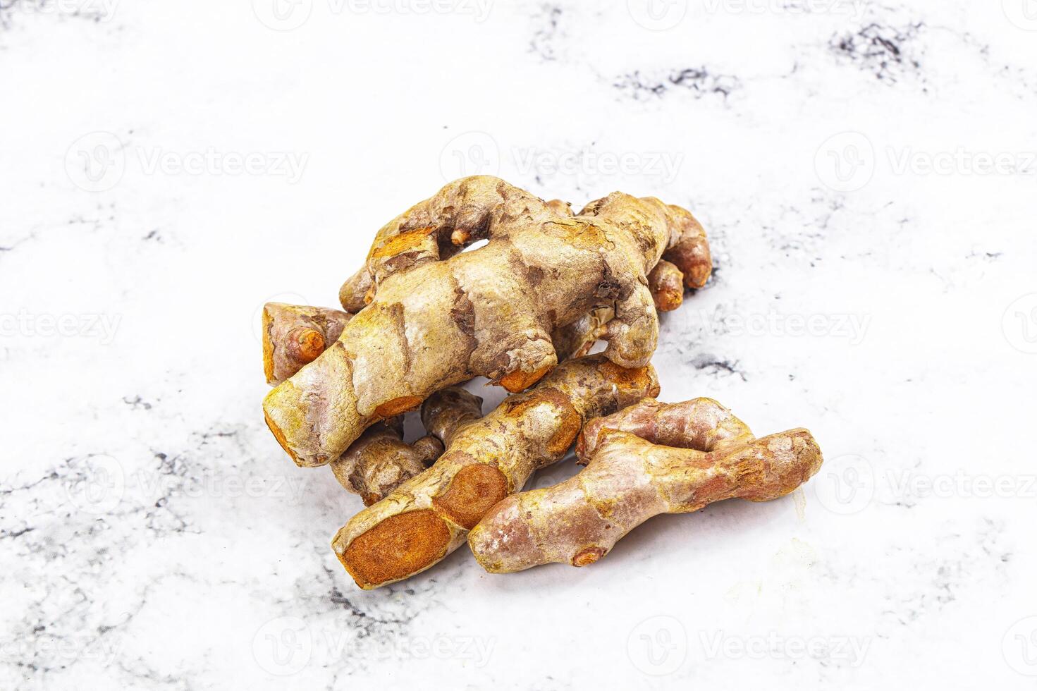 A close up of ginger root on a white surface photo