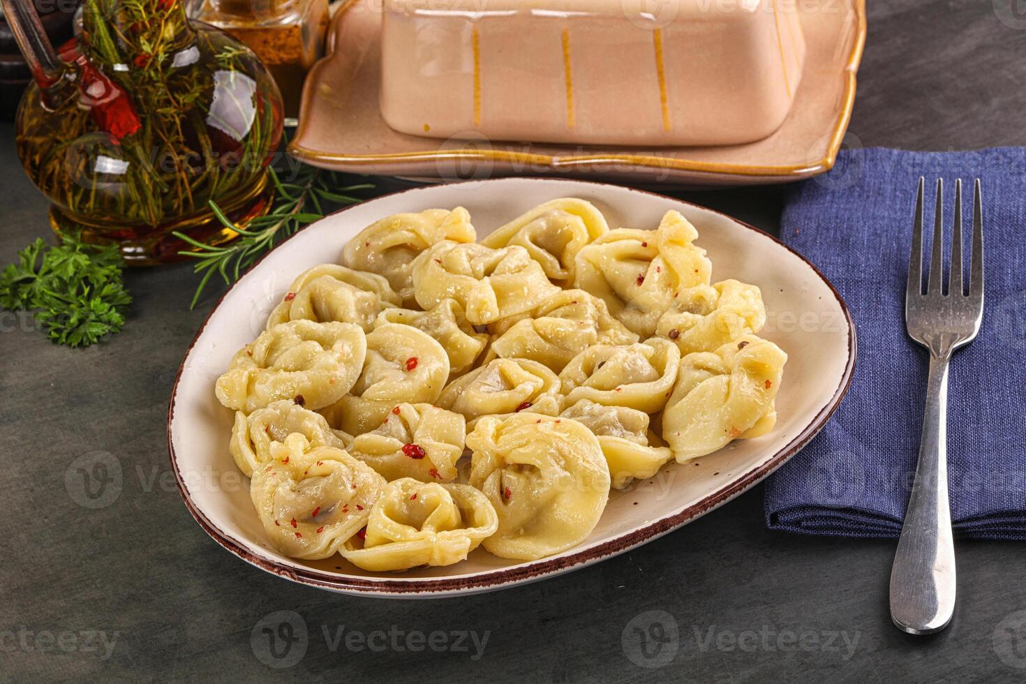 A plate of pasta with a fork and a knife photo
