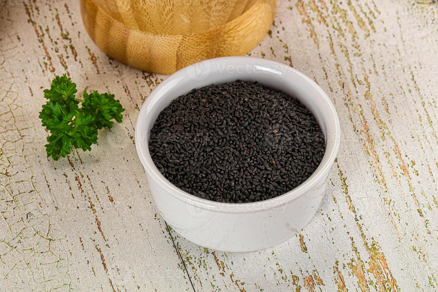 A bowl of black seed on a table photo